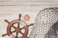 Boat rudder, rope and sea shell on wooden background