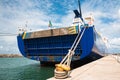 Boat`s Stern and Rope Tied to Yellow Rusted Bollard Royalty Free Stock Photo