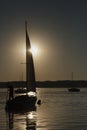 Boat with a sail, sunrise on the lake