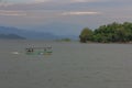 The boat sailed into the dam against blue sky and mountain