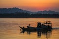 Boat sailing along the river at sunset
