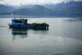 A Boat is sailing in calm water of Toba Lake, Samosir Island, North Sumatra, Indonesia.