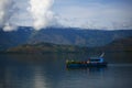 A Boat is sailing in calm water of Toba Lake, Samosir Island, North Sumatra, Indonesia.