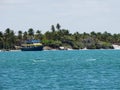 Boat sailing in the calm waters of MaceiÃÂ³, Brazil, with palm trees in the background.