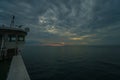 Boat sailing in cloudy stormy day during beautiful sunset Royalty Free Stock Photo