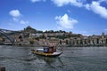 A boat sailing on the Douro River, Portugal. The boat is a rabelo, a traditional Portuguese cargo boat used to transport port wine Royalty Free Stock Photo