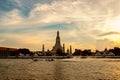 Boat sailing in the middle of the Chao Phraya River and Wat Arun, Bangkok Royalty Free Stock Photo