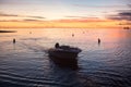 Boat sailing on the ocean at sunset.