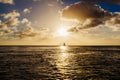 Boat sailing and plane taking off at sunset Royalty Free Stock Photo