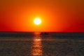 Boat sailing in the rays of the setting sun Royalty Free Stock Photo