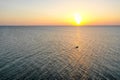 A boat sailing on the sea, early in the morning, beautiful sunrise as background. Aerial view Seascape. Local people fishing on a Royalty Free Stock Photo