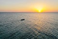 A boat sailing on the sea, early in the morning, beautiful sunrise as background. Aerial view Seascape. Local people fishing on a Royalty Free Stock Photo