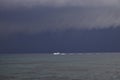 Boat sailing in the upcomming storm. Sailboat in bad weather sail at opened sea. Sailing yacht under heavy cloud sky. Royalty Free Stock Photo