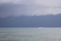 Boat sailing in the upcomming storm. Sailboat in bad weather sail at opened sea. Sailing yacht under heavy cloud sky. Royalty Free Stock Photo