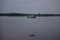 The boat sails on the river in the evening