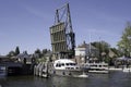 Boat sails on a river under the opened steel drawbridge