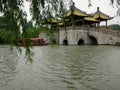 Boat Sails Under Chinese Bridge