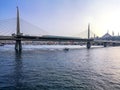 The boat sails under the Golden Horn Bridge in Istanbul Turkey. Beautiful seascape with modern railway bridge in turkish tourist Royalty Free Stock Photo