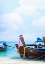 Boat on sand beach at coast with blue sea and blue sky. portrait with free space.