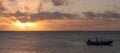 A boat on a sea during a beautiful sunset in Tonga Royalty Free Stock Photo