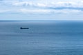 Boat at sea on the horizon