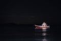 A boat on the sea at night