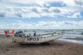 A boat on the sea shore with buoys and flags Royalty Free Stock Photo