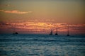 Boat on sea at sunset. Sailboats with sails. Ocean yacht along water. Royalty Free Stock Photo