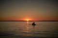 Boat in the sea with two fishermen in it, nets in the sea. Sunset or sunrise Royalty Free Stock Photo