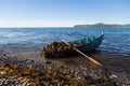 Boat with seaweed kelp stands near the shore. Royalty Free Stock Photo