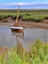 Boat in shallow water, Blakeney, North Norfolk coast, East Anglia, UK