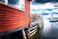 Boat shed and dock loaded with lobster traps overlooking a small harbour with fishing boats near Trinity Newfoundland
