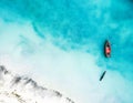 Boat and ship in beautiful turquoise ocean, top view