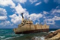 Boat shipwrecked near the rocky shore. Royalty Free Stock Photo