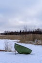 Boat on the shore of a frozen lake in Finland. Winter landscape, copy space Royalty Free Stock Photo