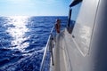 Boat side sailing in blue sea sun reflection Royalty Free Stock Photo