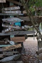 Boat signs and name plates with shells decorating a driftwood hut in Canada`s Inside Passage