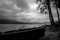 Boat silhouette in cloudy morning at lake Dospat Royalty Free Stock Photo