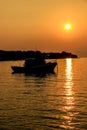 Boat silhouette in orange sunset