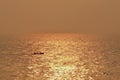 Boat silhouette in sea during sunset, golden hour