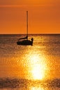 Boat silhouetted at sunset