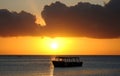 Boat silhouetted at sunset Royalty Free Stock Photo