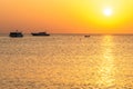 Boat silhouetts on the shores of the red sea at sunset in Makadi Bay Egypt golden colors