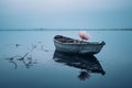 a boat with a single flower floating in the water Royalty Free Stock Photo