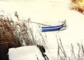 Boat in the snow at dawn on the river in winter Royalty Free Stock Photo