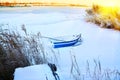 Boat in the snow at dawn on the river in winter Royalty Free Stock Photo