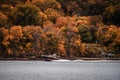Boat on the St Croix River with amazing orange trees in the background.