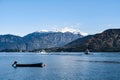 Boat stands on Lake Como against the backdrop of mountains and sailing yachts. Italy Royalty Free Stock Photo