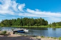 Boat station and a beautiful pier on the shore of the lake amidst the lush forests of the island of Valaam