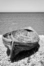 Boat on a stony seashore. Minimalistic black and white.